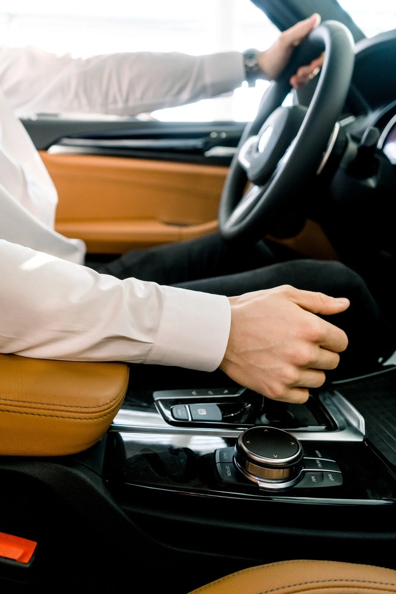 Man changing gears in a luxurious car